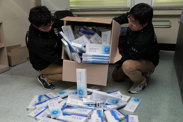 ▲선편우편물로품명을위장해밀수입한국산면세담배에쎄1000여갑(한화450만원)을폐기처분하고있다.(사진제공=부산세관)