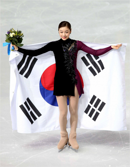 '진짜피겨여왕'소치올림픽당시김연아가경기를마친뒤태극기를들고팬들환호에답하는모습.(자료사진=대한체육회)