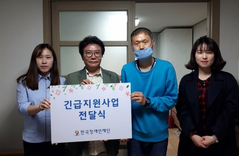 공 씨의 활동보조인(오른쪽 두 번째)에게 긴급지원금을 전달한 한국장애인재단 이성규 이사장(왼쪽 두 번째)과 관계자 (사진=한국장애인재단)