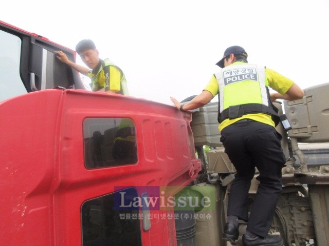 해경이 전복트럭 운전자를 구하고 있다.