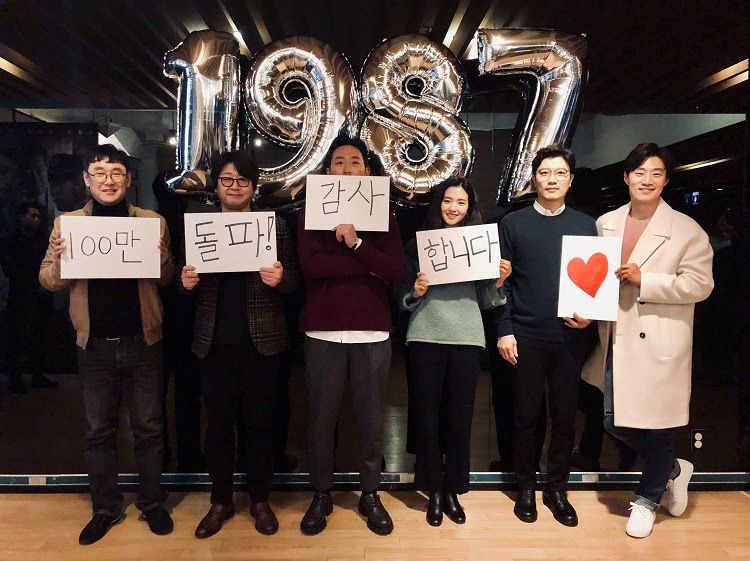 영화 '1987' 장준환 감독과 배우들이 '100만 돌파! 감사합니다♥''라고 쓰인 메시지를 들고 있다. (사진=CJ엔터테인먼트 제공)