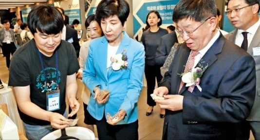 왼쪽부터 노순호 동구밭 대표, 김영주 고용노동부 장관, 윤여철 현대차그룹 부회장이 23일 열린 '청년 사회적 기업 육성 및 신중년 일자리 창출' 협약식에서 제품을 둘러보고 있다. (사진=현대자동차)