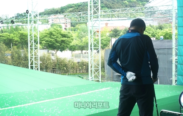 A씨가 골프연습 도중 허리 통증으로 쉬고있다.