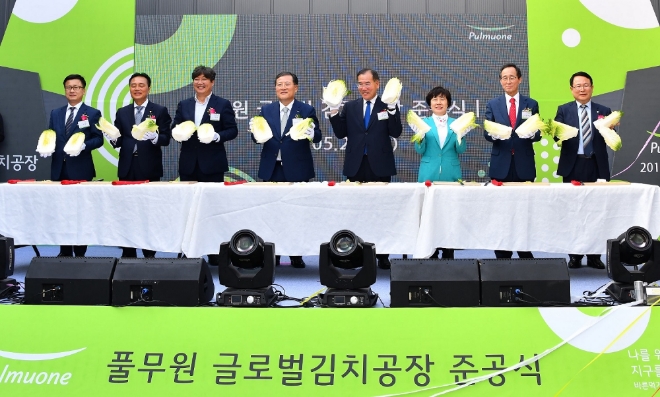 24일 전북 익산시 왕궁면 국가식품클러스터에 열린 '풀무원 글로벌김치공장 준공식'에서 이개호 농림축산식품부 장관(왼쪽에서 다섯번째) 등 참석자들이 글로벌김치공장의 새출범을 축하하는 이색적인 '배추 커팅 퍼포먼스'에서 예쁘게 직접 자른 배1추를 들어보이며 환하게 웃고 있다. / 사진 제공 = 풀무원