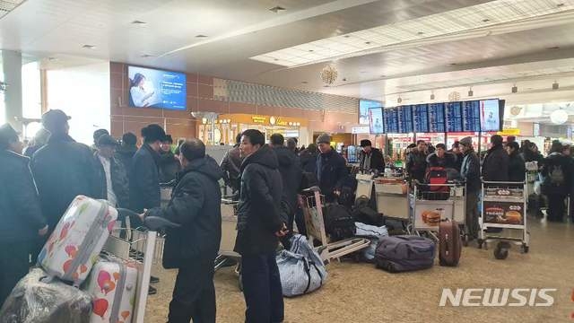 러시아 모스크바 공항에 북한 노동자들이 모여있는 모습