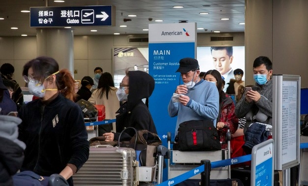 신종 코로나바이러스 감염증이 확산하는 가운데 30일(현지시간) 중국 베이징 서우두 국제공항에서 미국 로스앤젤레스행 비행기를 타려는 승객들이 마스크를 끼고 대기하고 있다