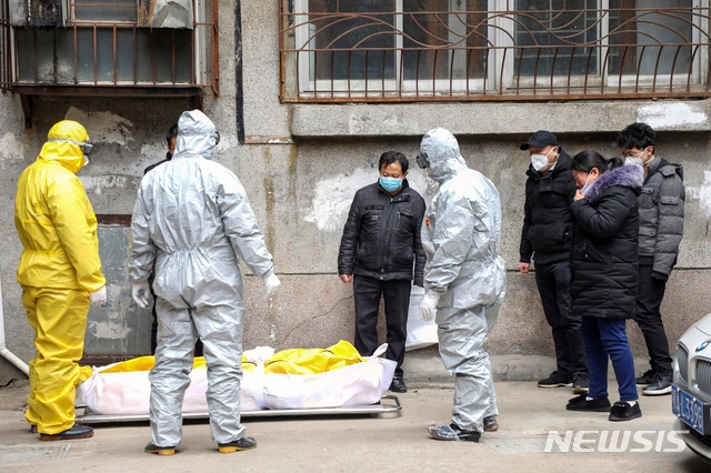 일 중국 후베이성 우한에서 신종 코로나 바이러스 감염증의 사망자 시신을 장의업 직원들이 옮기고 있다. 1월9일 첫 사망자가 나왔던 우한시 희생자 수가 1일 자정까지 220명을 육박했다.