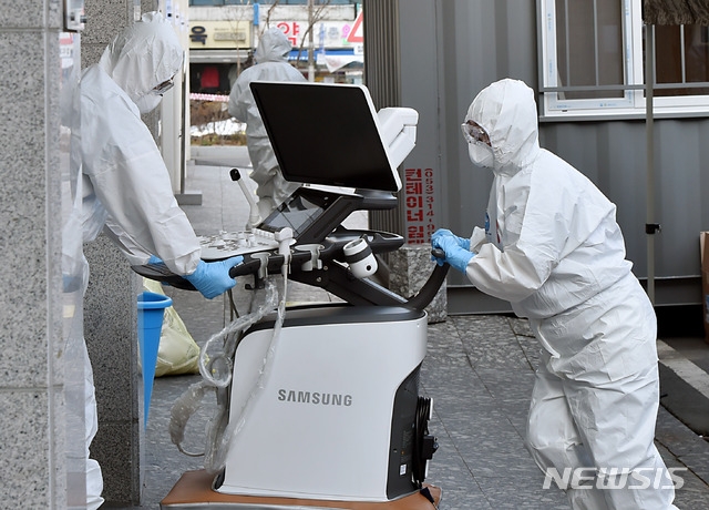 신종 코로나바이러스 감염증(코로나19) 확진자가 무더기로 늘어난 5일 오전 대구 중구 계명대학교 대구동산병원에서 의료진이 임산부 확진자 등에 대비해 사용할 초음파 진단기를 옮기고 있다.
