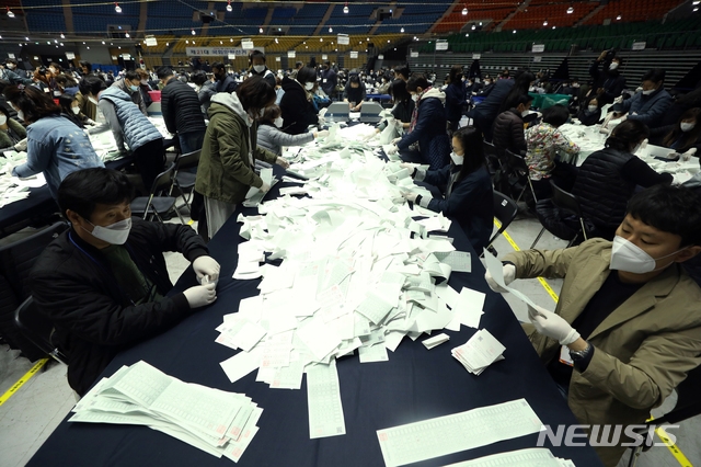 개표사무원들이 제21대 국회의원 선거일인 15일 서울 송파구 올림픽 체조경기장에 마련된 개표소에서 개표하고 있다.