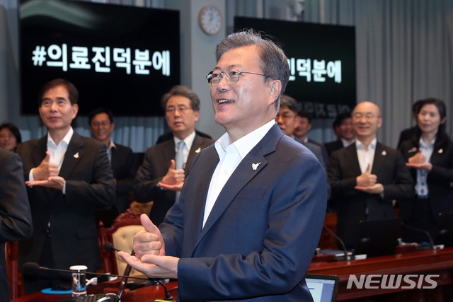 문재인 대통령이 지난 27일 오후 청와대에서 수석·보좌관 회의에 참석해 신종 코로나바이러스 감염증(코로나19) 의료인에게 고마움을 전하는 '덕분에 챌린지'를 하고 있다.