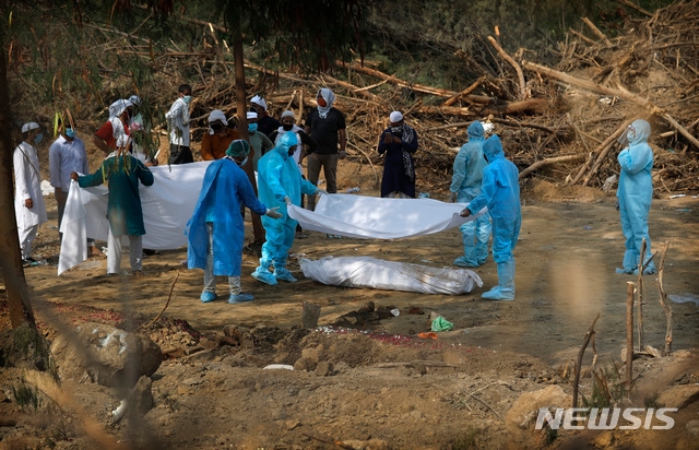 지난 6월 10일(현지시간) 인도 뉴델리의 한 공동묘지에서 사람들이 신종 코로나바이러스 감염증(코로나19)으로 사망한 친척을 매장하고 있다. 인도는 최근 코로나19 봉쇄를 완화하면서 확진 사례가 급증해 당국이 대재앙을 막기 위한 충분한 조치를 했는지 의문이 제기되고 있다