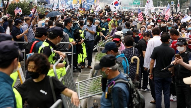 보수단체 집회 참가자들이 지난 15일 오전 서울 종로구 광화문광장에서 8·15 국민대회 집회중 경찰이 세워놓은 바리게이트를 넘어 도로로 나오고 있다.