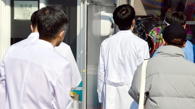 14일 오후 광주 동구 전남대학교병원 응급실 입구에서 의사들이 신종 코로나바이러스 감염증(코로나19) 검사를 받고 있다. 전남대병원에서는 의사 등 3명이 코로나19 확진 판정을 받았다.