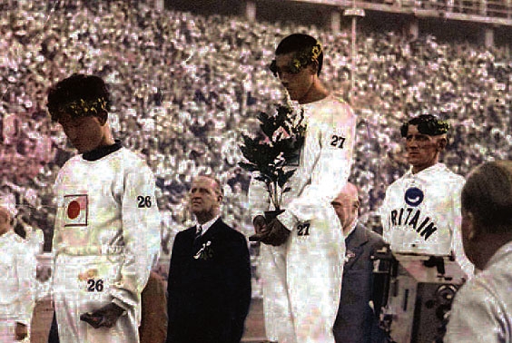 1936년 베를린올림픽 마라톤 시상식 광경, 2위 영국의 하퍼가 고개를 들고 있는 데 견주어 금메달리스트인 손기정(가운데)과 남승룡(앞쪽)은 고개를 숙인채 깊은 생각에 잠겨 있는 모습이다. . 