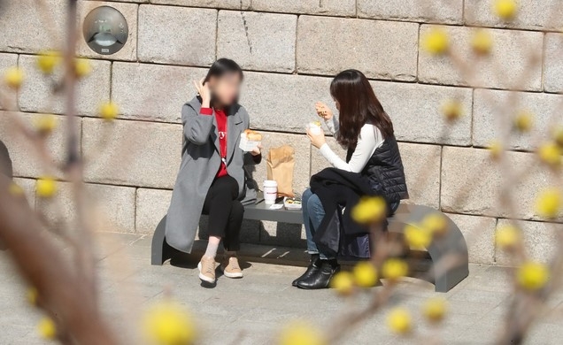 지난 5일 오후 서울 종로구 청계천을 찾은 시민들이 햇살을 맞으며 점심을 먹고 있다. 