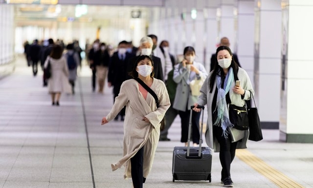 일본 수도 도쿄에서 23일 코로나19 예방을 위해 마스크를 쓴 시민들이 지하철역을 향해 바쁘게 발걸음을 옮기고 있다.