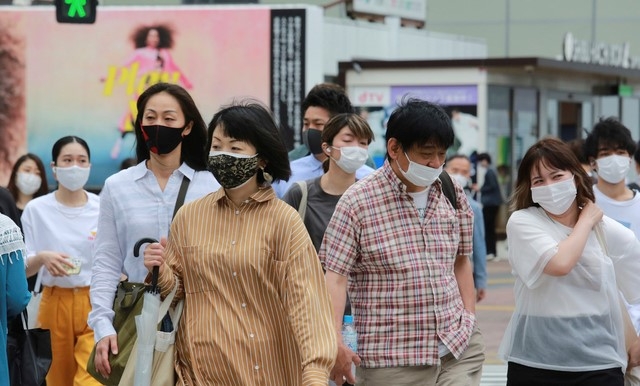 18일 일본 도쿄에서 코로나19 감염을 예방하기 위해 마스크를 착용한 시민들이 거리를 걷고 있다.