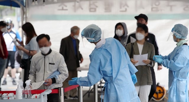 국내 신종 코로나바이러스 감염증(코로나19) 신규 확진자가 619명으로 사흘째 600명대를 보인 17일 오전 서울 중구 서울역 임시선별검사소를 찾은 시민들이 검사를 받기 위해 줄을 서고 있다.
