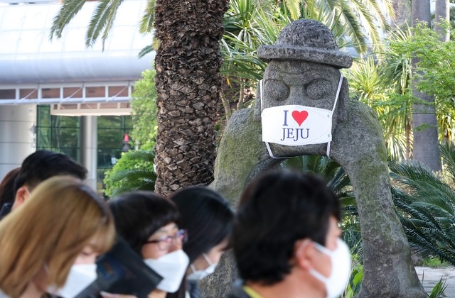 제주국제공항에 서 있는 돌하르방이 신종 코로나바이러스 감염증(코로나19) 예방 마스크를 쓰고 있다.