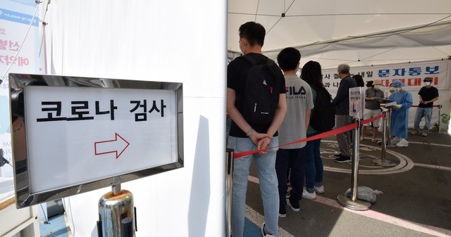 대구지역 코로나19 확진자가 18명으로 집계된 21일 오전 대구 수성구 보건소 코로나19 선별진료소에서 시민들이 검사를 받기 위해 줄 서 기다리고 있다.