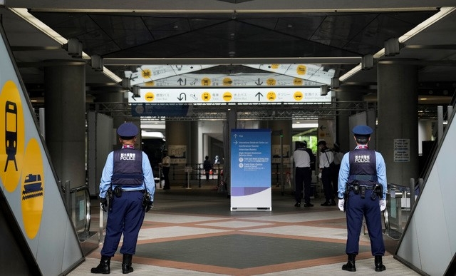 13일 일본 도쿄의 2020 도쿄올림픽 메인 프레스센터 앞에서 경찰관 두 명이 경비를 서고 있다. 코로나19로 개막이 연기됐던 2020 도쿄올림픽은 오는 23일 무관중으로 개막한다.