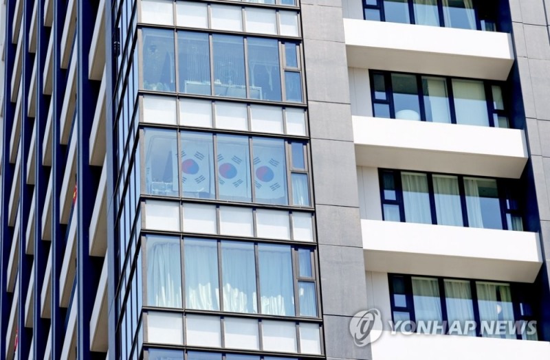 (도쿄=연합뉴스) 도쿄올림픽 개막을 하루 앞둔 22일 오전 도쿄 하루미 지역 올림픽선수촌 인근 고층건물 창문에 태극기가 걸려 있다.