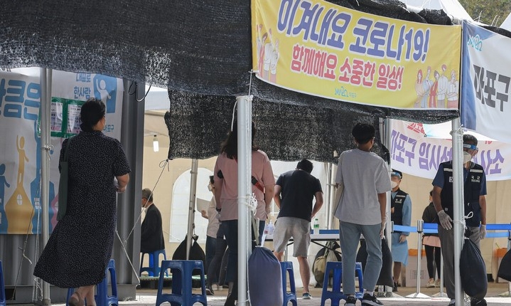 코로나19 신규 확진자가 1,804명으로 60일째 네 자릿수로 집계된 4일 오전 서울 마포구 서강대역사 임시선별검사소에서 시민들이 검사를 받기 위해 대기하고 있다.