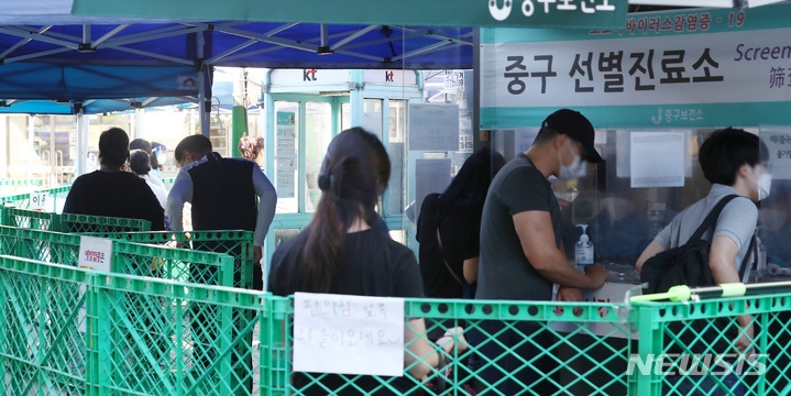 18일 오전 서울 중구보건소 선별진료소를 찾은 시민들이 코로나19 검사를 받기 위해 대기하고 있다. 