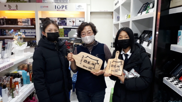 청소년들, 우드버닝으로 제작한 목포오래가게 작품 기증 모습.