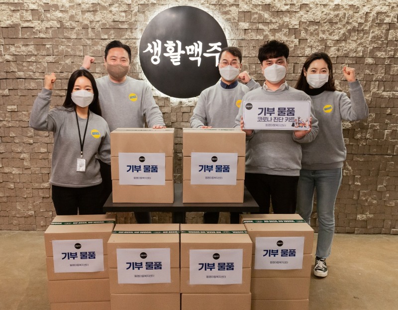사진: 생활맥주 직원들이 동명아동복지센터에 기부하고 기념촬영하고 있다. 생활맥주 제공