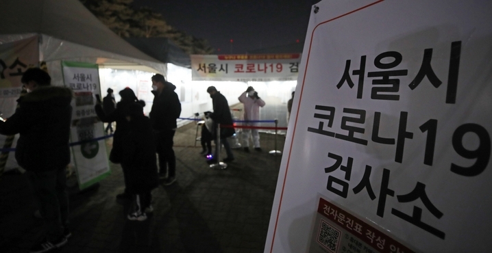 코로나19 신규 확진자가 9만3135명으로 역대 최다를 기록한 17일 오후 서울 마포구 월드컵공원 평화광장 임시선별검사소에서 시민들이 검사를 받기 위해 대기하고 있다.