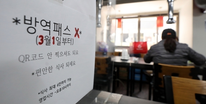 식당 카페 등 다중이용시설에 대한 코로나19 접종증명·음성확인제(방역패스) 제도 잠정 중단을 하루 앞둔 28일 오후 서울 시내 한 음식점에서 방역패스 중단과 관련한 안내문이 부착돼 있다.
