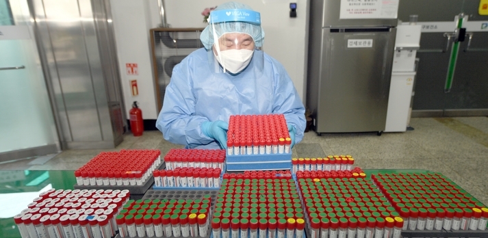 광주와 전남지역 코로나19 하루 확진자가 7000명대까지 치솟은 가운데 23일 오후 광주 남구 선별진료소에서 방역요원이 오전에 채취된 검체를 수탁기관으로 보내기 위해 분류하고 있다.
