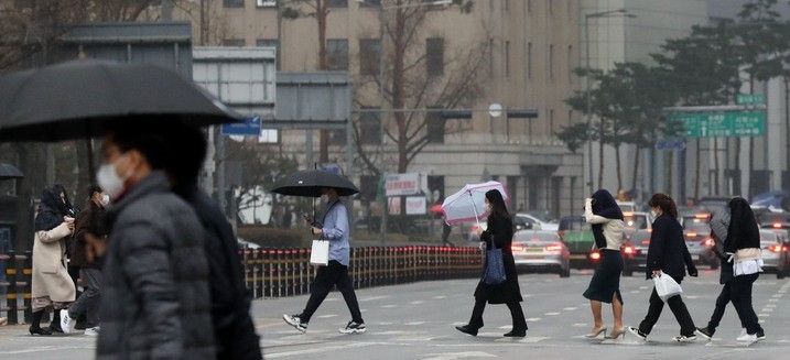 전국적으로 봄비가 내린 지난달 14일 오후 서울 중구 을지로에서 미처 우산을 준비하지 못한 시민들이 외투를 머리에 쓰고 걸어가고 있다.