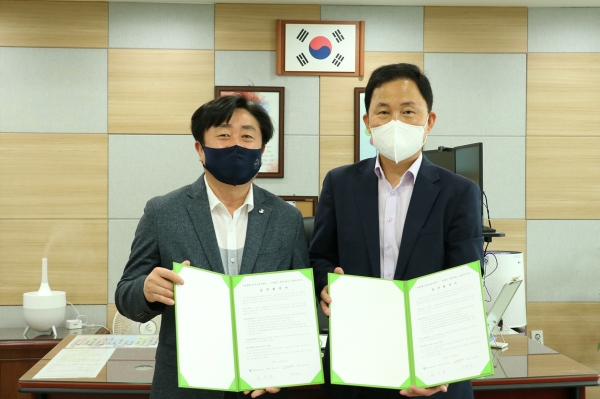 사진은 사회공헌협약식 업무협약서를 들고 있는 모습. 왼쪽부터 김문호 서울문교초등학교 교장과 홍성철 서울특별시남부교육지원청 교육장.