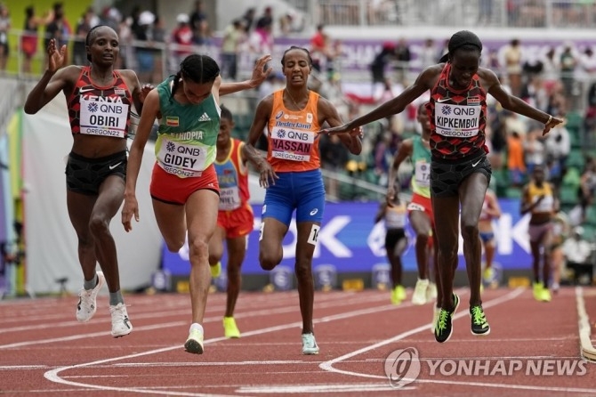 (유진 AP=연합뉴스) 지데이(왼쪽 두 번째)이 17일(한국시간) 미국 오리건주 유진에서 열린 여자 10,000ｍ 결선에서 가장 먼저 결승선을 통과하고 있다. 여자 선수들 이름표 위에는 여자 경기 스폰서인 'QNB'라는 카타르 국립은행 영어 약자가 보인다.  