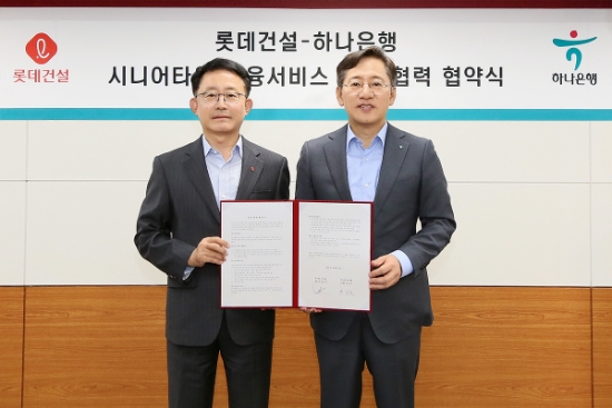 하나은행은 28일 오후 서울 서초구 롯데건설 본사에서 롯데건설(대표이사 하석주)과 시니어 손님 대상으로 최적의 맞춤형 자산관리 서비스 제공을 위한 업무협약을 체결했다. 업무협약식에 참석한 박성호 하나은행장(사진 오른쪽)과 하석주 롯데건설 대표이사(사진 왼쪽)이 함께 업무협약서를 들고 기념 촬영을 하고 있다.