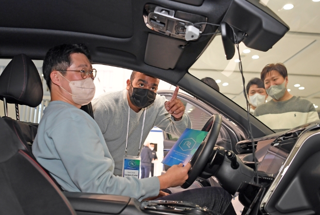 타트업 스마트 오디오(Smart Audio)의 ‘주변 소음을 제거해 운전자의 목소리만 인식하는 사운드 솔루션’에 대한 설명을 듣는 모습