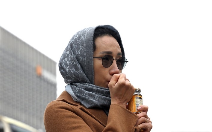 밤사이 내리던 비가 그치고 체감온도가 뚝 떨어진 지난 13일 오전 서울 중구 청계광장에서 스카프를 착용한 외국인 관광객이 움츠리고 있다.