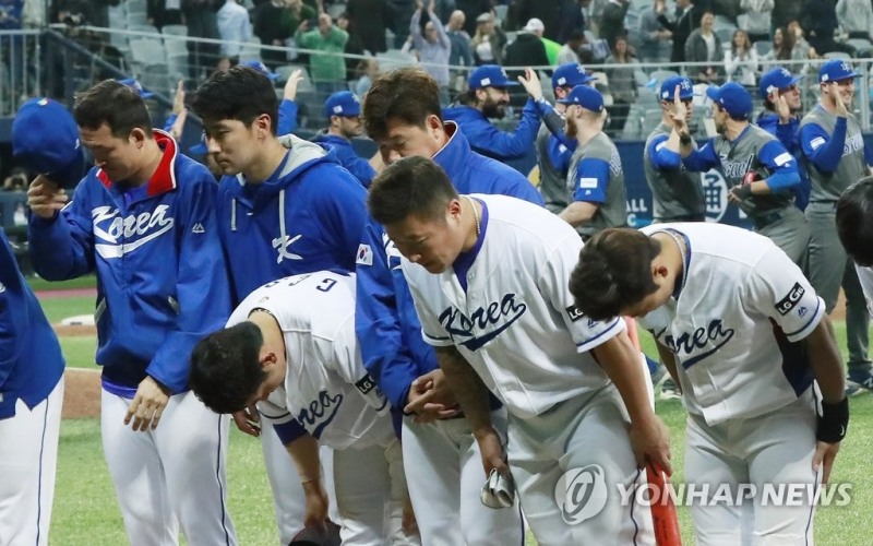 이스라엘 선수들이 환호하고 있는 가운데 한국 선수들이 팬들에게 사죄의 인사를 하고 있다.