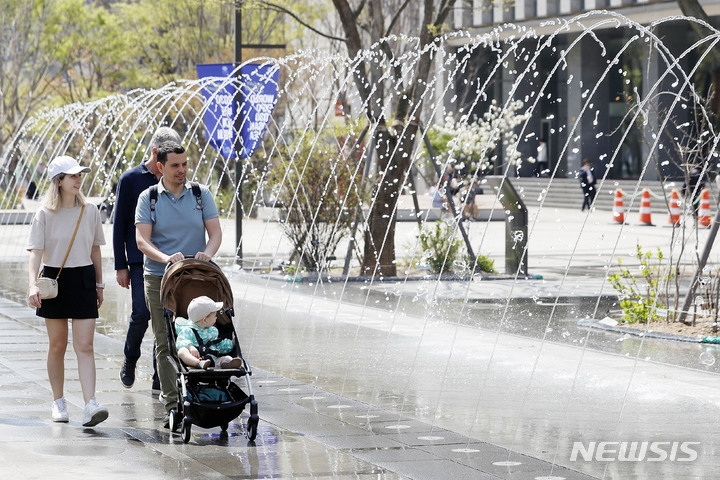 초여름 날씨를 보인 지난 3일 서울 광화문 광장에서 외국인들이 분수대 옆을 걷고 있다.