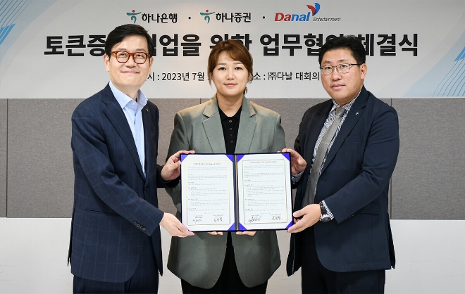 하나은행과 하나증권은 다날엔터테인먼트와 지난 12일 콘텐츠 기반의 토큰증권 생태계 구축 및 공동 비즈니스 발굴을 위한 업무협약을 체결했다.사진 왼쪽부터 정재욱 하나은행 디지털전략본부장, 임유엽 다날엔터테인먼트 대표, 최원영 하나증권 디지털본부 상무가 협약서를 들고 기념촬영을 하고 있다. / 사진=하나은행 제공