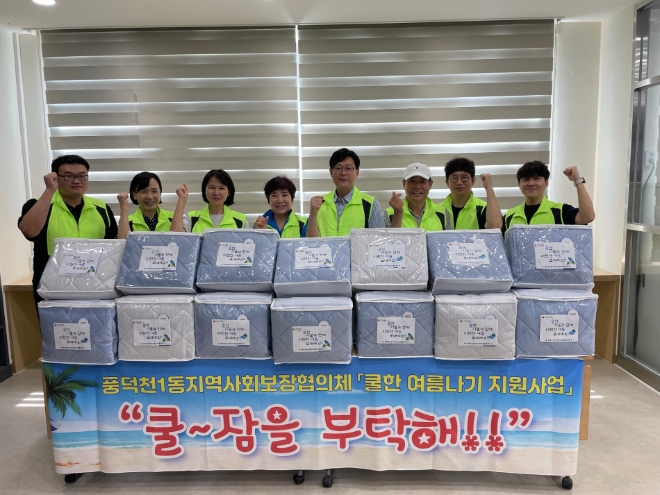 용인시 수지구 풍덕천 1동 지역사회보장협의체가 저소득층에 쿨잠매트를 전달하고 있다.(사진=용인시)
