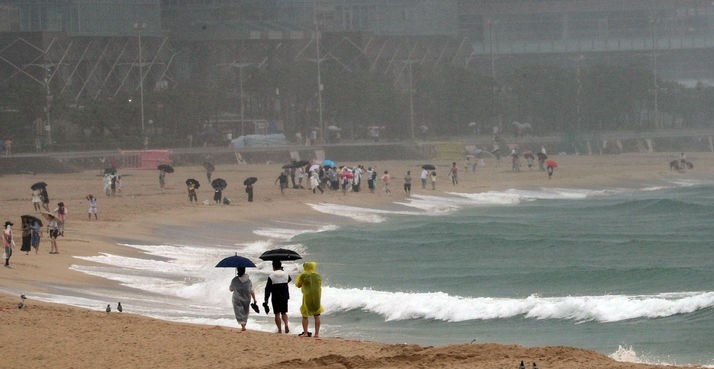  6호 태풍 '카눈'이 북상 중인 9일 오후 부산 해운대구 해운대해수욕장을 찾은 시민과 관광객들이 이동하고 있다.