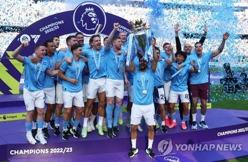 지난 시즌 EPL 우승을 차지한 맨체스터시티 선수들이 우승컵을 들어올리며 환호하고 있다.