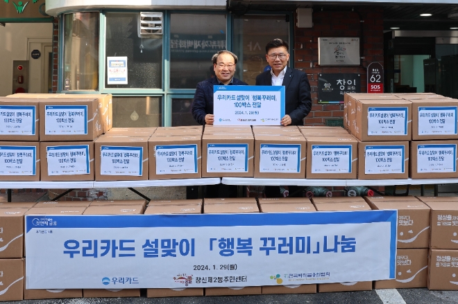 지난 29일 종로구 창신2동 주민센터에서 진행된 설 맞이 행복 꾸러미전달 행사에서 이기수 우리카드 경영기획본부장(오른쪽)과 마호식 창신2동장이 기념사진을 촬영하고 있다