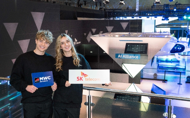 MWC24 SKT 전시관에 마련된 글로벌 텔코 AI 얼라이언스(GTAA) 조형물을 배경으로 포즈를 취한 현지 모델들. / 사진=SKT 제공