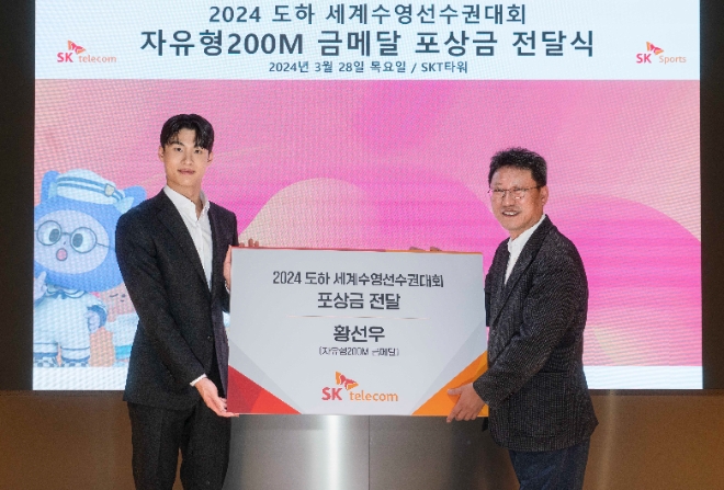 SK텔레콤(SKT)은 지난 2월 카타르 도하 세계수영선수권대회에서 뛰어난 성적을 거둔 황선우 선수를 위한 포상식을 열고, 특별 포상금을 지급했다고 29일 밝혔다. 사진은 (좌측부터)황선우 선수와 SKT 김희섭 커뮤니케이션 담당이 기념 촬영을 하는 모습. (사진 = SKT 제공)