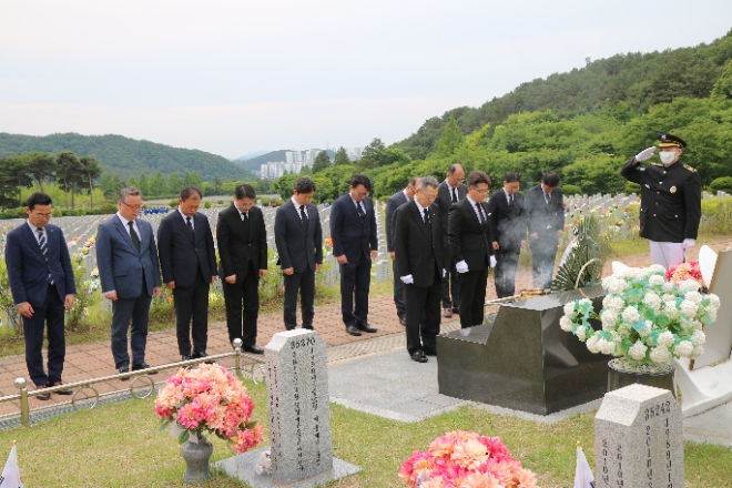 한화그룹은 대전·충청지역 사업장 임직원들이 30일 국립대전현충원을 찾아 현충탑을 참배하고 묘역 정화활동을 펼쳤다고 밝혔다. 사진은 한화그룹 충청지역 봉사단이 국립대전현충원에서 묘역정화활동 등 봉사활동을 앞두고 천안함 장병 묘역을 참배하고 있는 모습. (사진 = 한화그룹 제공)