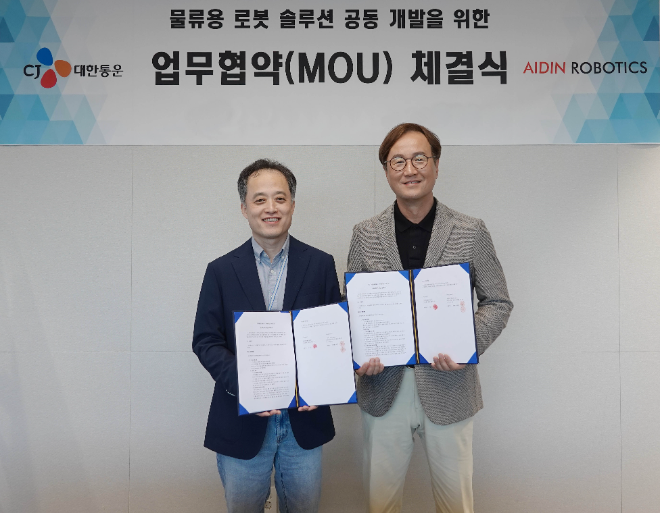 24일 CJ대한통운 본사에서 진행된 MOU 행사에 참여한 CJ대한통운 김정희 TES물류기술연구소장과 에이딘로보틱스 최혁렬 대표가 협약서를 들고 기념사진을 찍고 있다. ⓒCJ대한통운